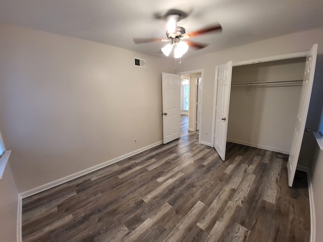4587 Sumner Wells Rd, Memphis, TN 38118 - unfurnished bedroom with dark wood finished floors, a closet, and a ceiling fan