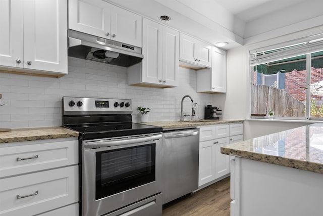 5841 Park Ave Unit 2, Memphis, TN 38119 - kitchen with appliances with stainless steel finishes, under cabinet range hood, white cabinetry, and light wood-type flooring