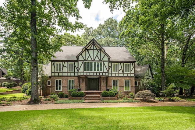 6470 Corsica Dr, Memphis, TN 38120 - tudor house with a front yard, brick siding, and stucco siding