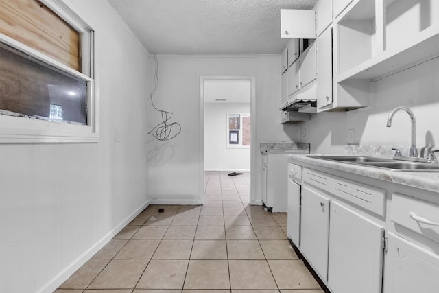 3594 Sunrise St, Memphis, TN 38127 - kitchen featuring a textured ceiling, white cabinetry, light countertops, light tile patterned floors, and under cabinet range hood