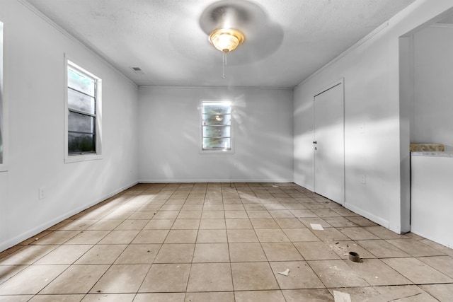 3594 Sunrise St, Memphis, TN 38127 - empty room with a textured ceiling, light tile patterned flooring, ornamental molding, and a ceiling fan