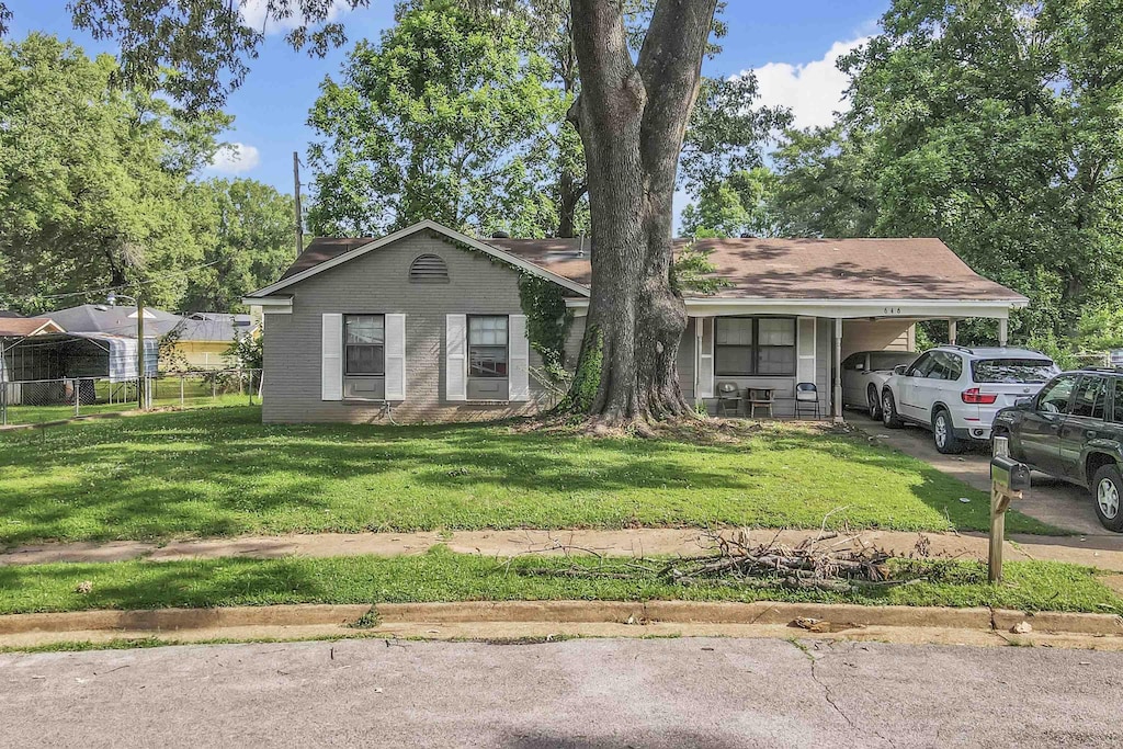646 Semple Ave, Memphis, TN 38127 - view of front of home featuring an attached carport, brick siding, and driveway