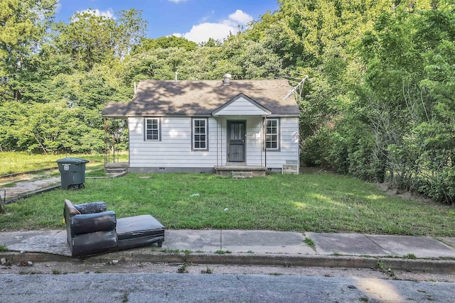 3021 Sunrise St, Memphis, TN 38127 - view of front facade with a front yard and a wooded view