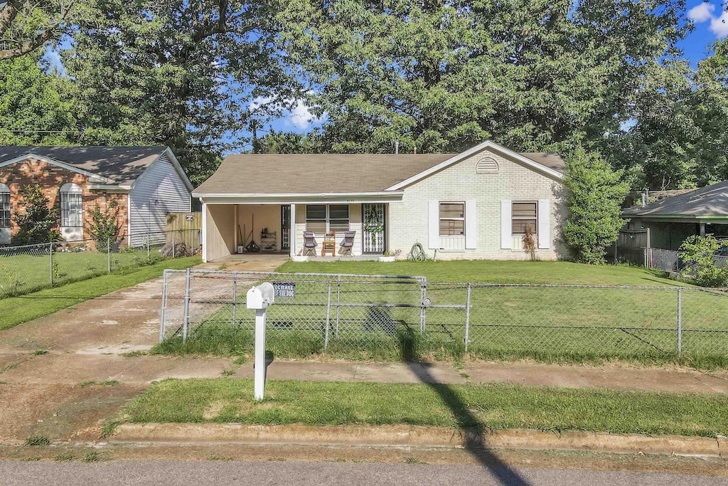 3255 Benjestown Rd, Memphis, TN 38127 - view of front of house with covered porch, a fenced front yard, an attached carport, and concrete driveway