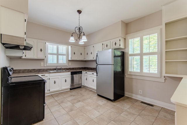 117 N High St, Waynesboro, TN 38485 - kitchen with appliances with stainless steel finishes, exhaust hood, dark countertops, and a chandelier