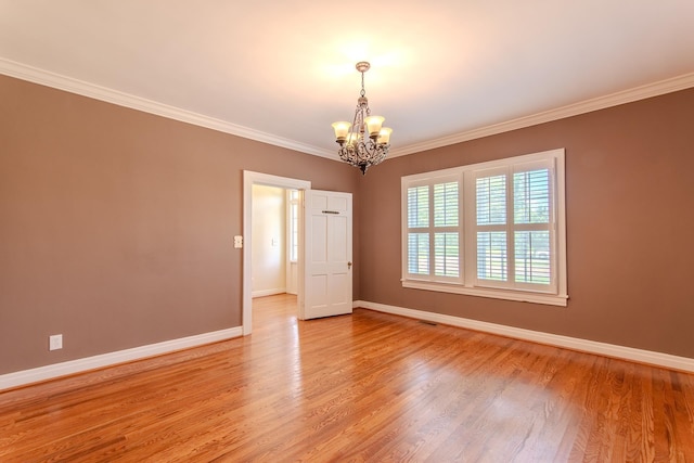 117 N High St, Waynesboro, TN 38485 - empty room featuring a chandelier, ornamental molding, and light wood-style flooring