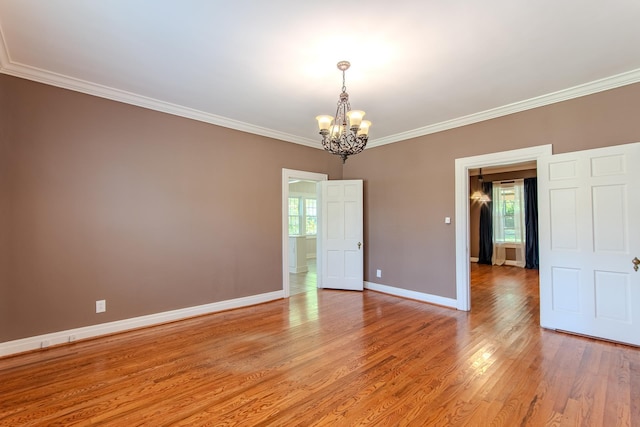 117 N High St, Waynesboro, TN 38485 - unfurnished room with a chandelier, light wood-style floors, and crown molding