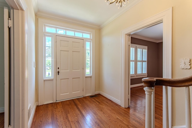 117 N High St, Waynesboro, TN 38485 - foyer entrance with healthy amount of natural light, crown molding, light wood-style floors, and a chandelier