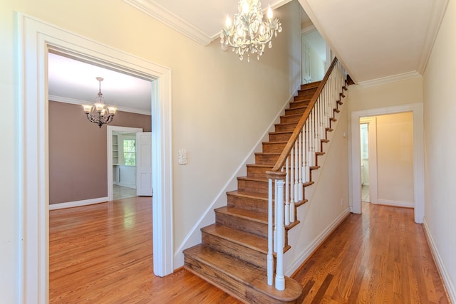 117 N High St, Waynesboro, TN 38485 - stairway with a chandelier, wood finished floors, and crown molding