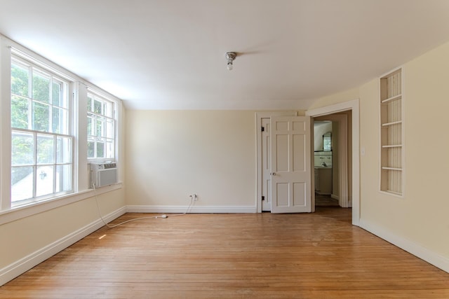 117 N High St, Waynesboro, TN 38485 - empty room featuring light wood finished floors, cooling unit, and built in features
