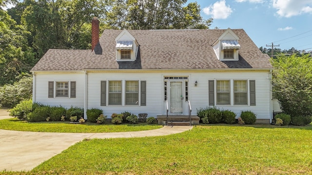 117 N High St, Waynesboro, TN 38485 - cape cod home featuring a chimney, a front yard, and roof with shingles