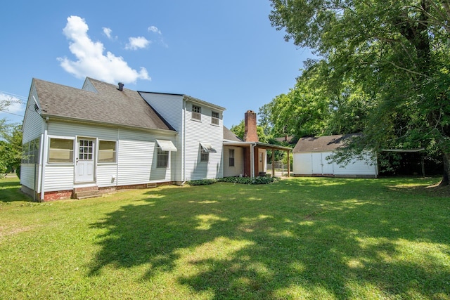 117 N High St, Waynesboro, TN 38485 - back of house with entry steps, roof with shingles, a lawn, and a shed
