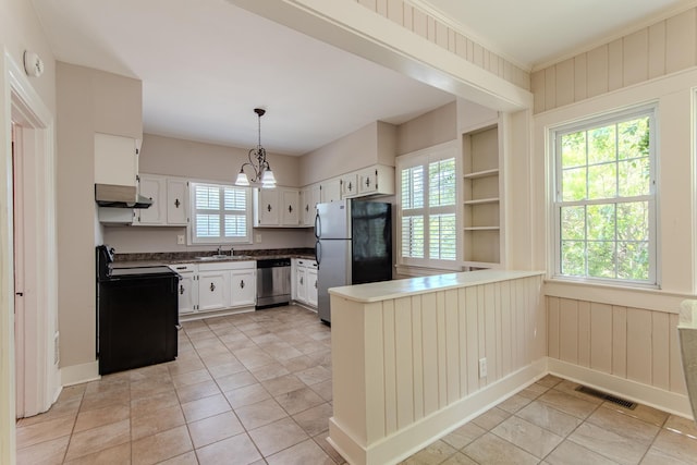 117 N High St, Waynesboro, TN 38485 - kitchen with stainless steel appliances, a peninsula, range hood, white cabinets, and a chandelier