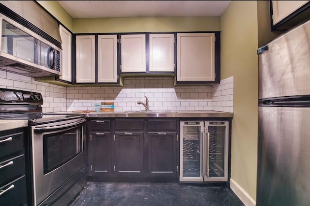 109 N Main St Unit 603, Memphis, TN 38103 - kitchen featuring appliances with stainless steel finishes, beverage cooler, decorative backsplash, and concrete floors