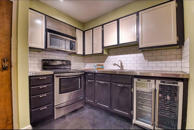 109 N Main St Unit 603, Memphis, TN 38103 - kitchen featuring stainless steel appliances, decorative backsplash, beverage cooler, and finished concrete flooring