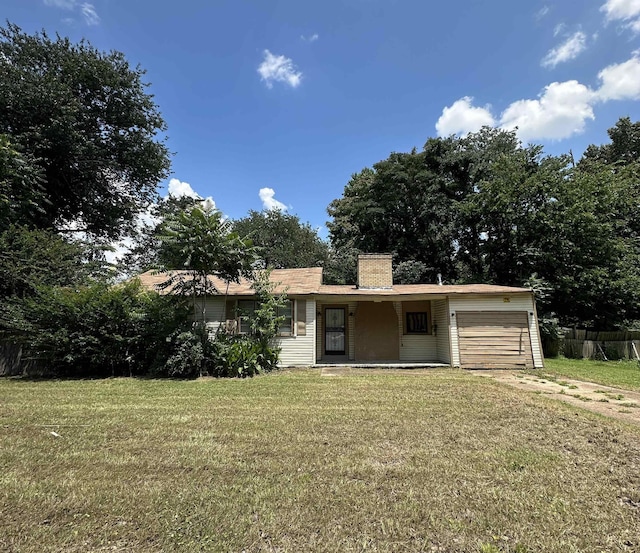 2442 Manchester Rd, Memphis, TN 38114 - view of front facade with a garage, a front lawn, and a chimney