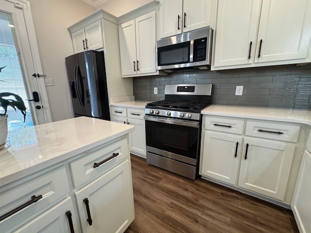 7412 Lost Trail Dr, Cordova, TN 38016 - kitchen featuring stainless steel appliances, dark wood-type flooring, backsplash, white cabinetry, and crown molding