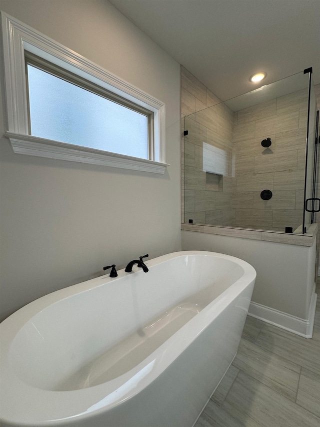 7412 Lost Trail Dr, Cordova, TN 38016 - bathroom featuring a soaking tub, a tile shower, and recessed lighting