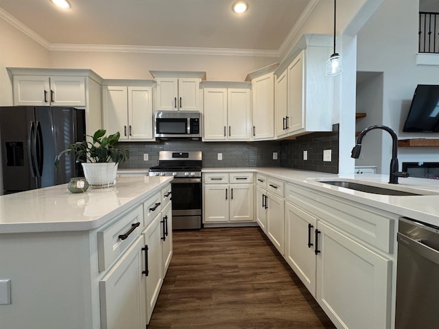 7412 Lost Trail Dr, Cordova, TN 38016 - kitchen with appliances with stainless steel finishes, recessed lighting, white cabinetry, crown molding, and dark wood-style flooring