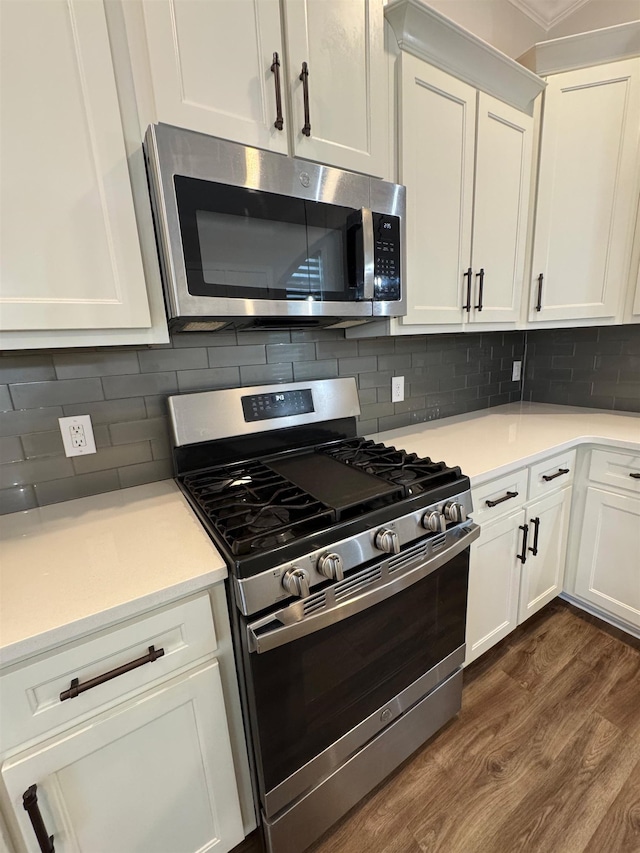 7412 Lost Trail Dr, Cordova, TN 38016 - kitchen with stainless steel appliances, dark wood-style flooring, white cabinetry, light countertops, and tasteful backsplash