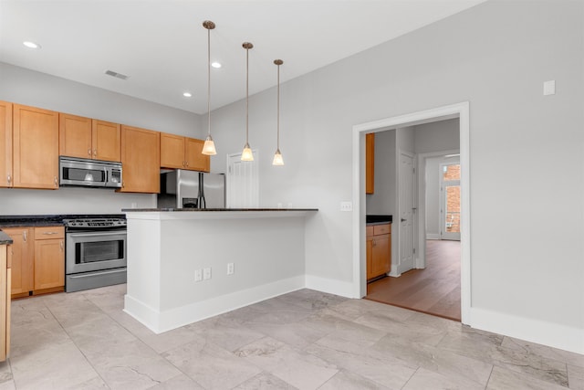 621 Denmark Dr Unit 201, Memphis, TN 38103 - kitchen with appliances with stainless steel finishes, dark countertops, recessed lighting, hanging light fixtures, and a peninsula