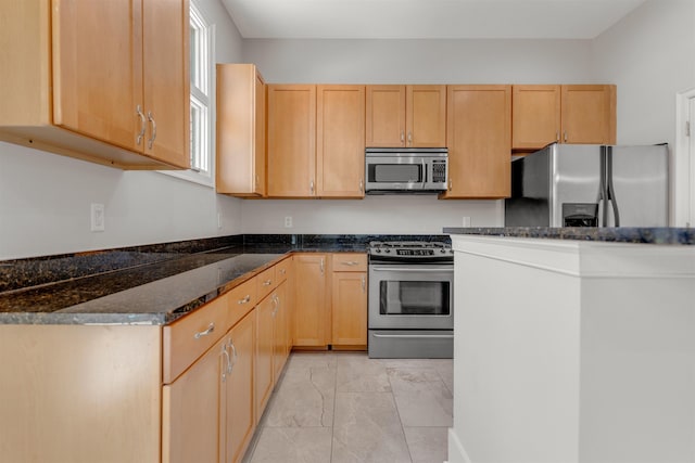 621 Denmark Dr Unit 201, Memphis, TN 38103 - kitchen with appliances with stainless steel finishes, light marble finish floors, light brown cabinets, and dark stone countertops
