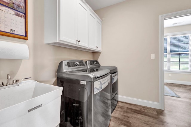 620 N Reid-Hooker Rd, Eads, TN 38028 - laundry area featuring washer and dryer, wood finished floors, and cabinet space