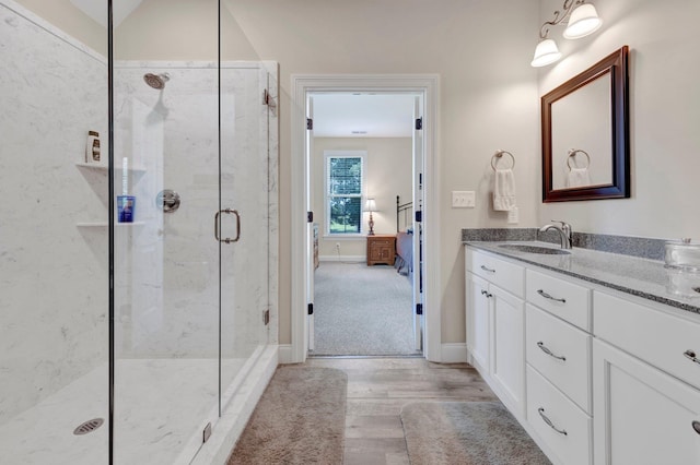 620 N Reid-Hooker Rd, Eads, TN 38028 - bathroom with wood finished floors, a marble finish shower, and vanity