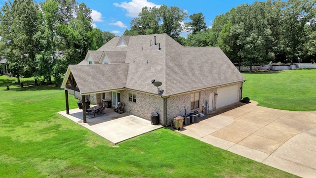 620 N Reid-Hooker Rd, Eads, TN 38028 - back of property with a shingled roof, concrete driveway, an attached garage, view of scattered trees, and a patio area