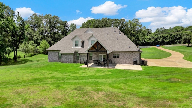 620 N Reid-Hooker Rd, Eads, TN 38028 - back of property featuring a patio area, a lawn, a shingled roof, and brick siding