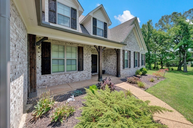 620 N Reid-Hooker Rd, Eads, TN 38028 - view of front of house with a porch, brick siding, a front lawn, and a shingled roof