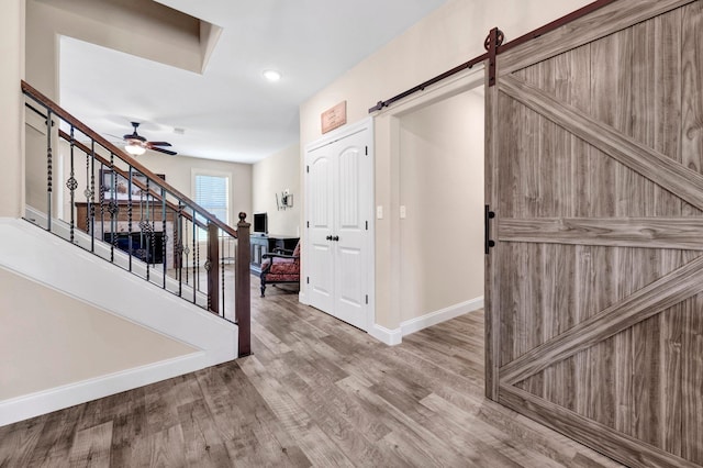 620 N Reid-Hooker Rd, Eads, TN 38028 - foyer entrance featuring ceiling fan, wood finished floors, a barn door, stairs, and recessed lighting
