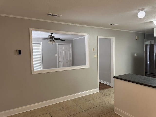 475 Ginny Ln, Collierville, TN 38017 - kitchen with freestanding refrigerator, tile patterned flooring, ceiling fan, dark countertops, and ornamental molding