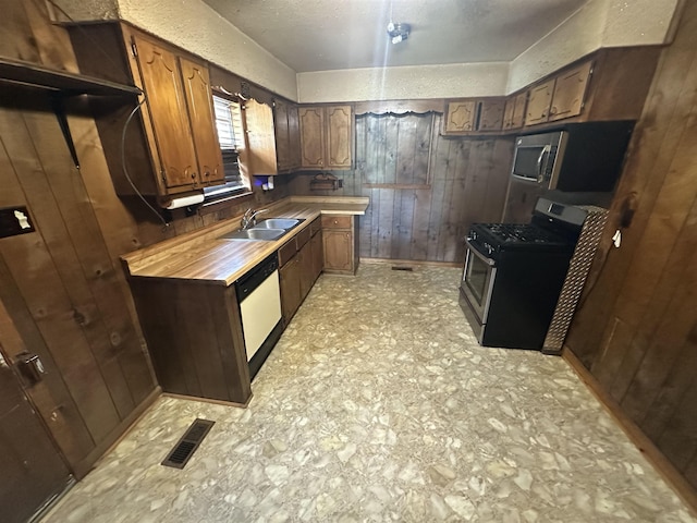 208 Sycamore Rd, Collierville, TN 38017 - kitchen featuring stainless steel appliances and wood walls