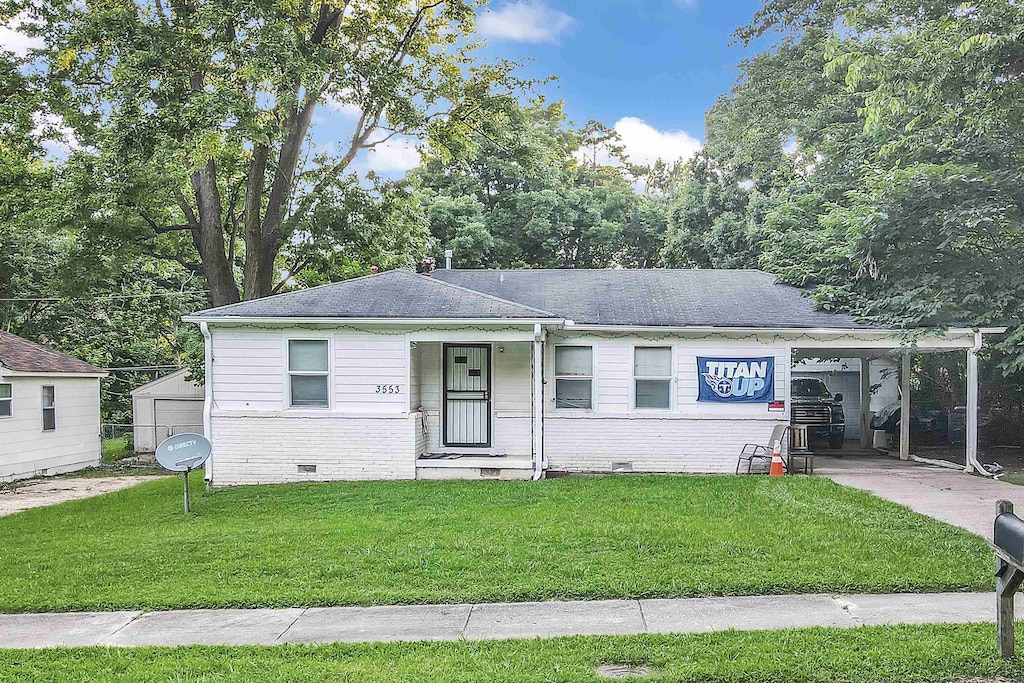 3553 Randolph St, Memphis, TN 38127 - view of front of property featuring crawl space, a front yard, brick siding, and an attached carport