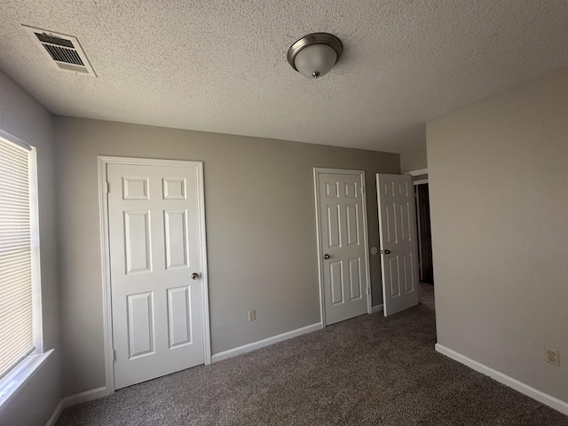 7029 Petten Cv, Memphis, TN 38133 - unfurnished bedroom featuring multiple windows, carpet, and a textured ceiling