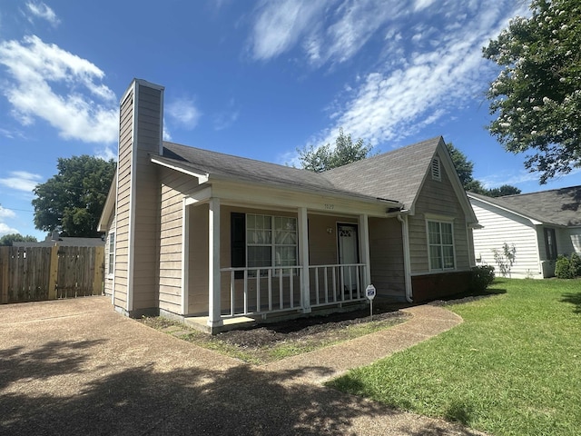 7029 Petten Cv, Memphis, TN 38133 - view of front of home with a porch, a chimney, and a shingled roof