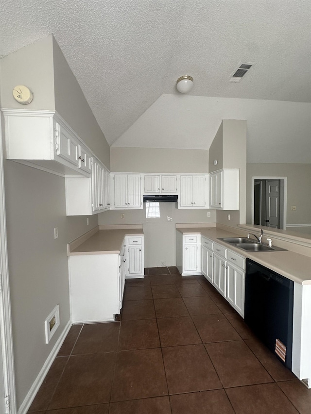 7029 Petten Cv, Memphis, TN 38133 - kitchen with dishwasher, a peninsula, vaulted ceiling, dark tile patterned floors, and a textured ceiling