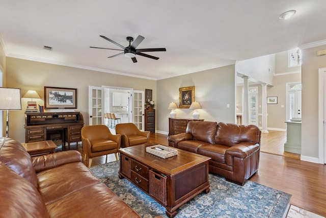 927 Oakmont Ridge Cv, Collierville, TN 38017 - living room featuring ceiling fan, ornate columns, wood finished floors, and crown molding