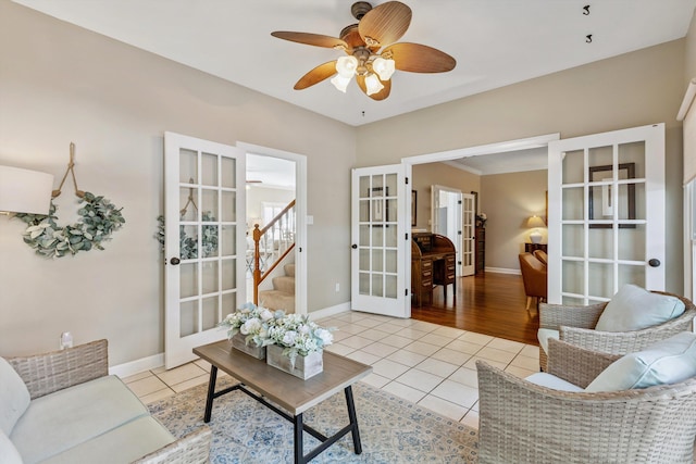 927 Oakmont Ridge Cv, Collierville, TN 38017 - living room featuring french doors, light tile patterned floors, a ceiling fan, and stairs
