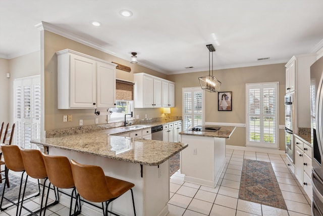 927 Oakmont Ridge Cv, Collierville, TN 38017 - kitchen with appliances with stainless steel finishes, a center island, a peninsula, white cabinetry, and light tile patterned floors
