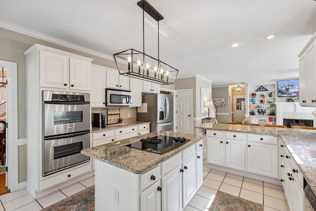 927 Oakmont Ridge Cv, Collierville, TN 38017 - kitchen featuring stainless steel appliances, crown molding, a center island, white cabinetry, and a chandelier