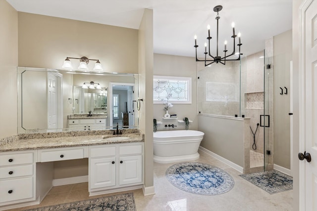927 Oakmont Ridge Cv, Collierville, TN 38017 - bathroom featuring a shower stall, a soaking tub, a chandelier, vanity, and tile patterned floors
