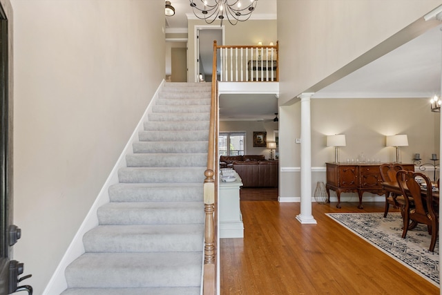 927 Oakmont Ridge Cv, Collierville, TN 38017 - staircase with ornamental molding, wood finished floors, a chandelier, and decorative columns