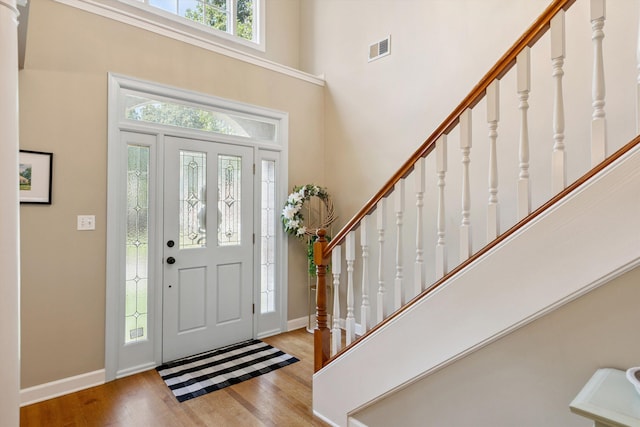 927 Oakmont Ridge Cv, Collierville, TN 38017 - foyer entrance with a towering ceiling, wood finished floors, and stairway