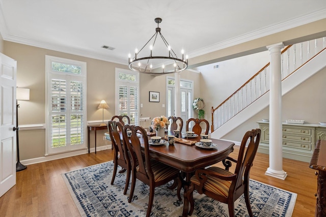 927 Oakmont Ridge Cv, Collierville, TN 38017 - dining space featuring a chandelier, wood finished floors, crown molding, and stairs