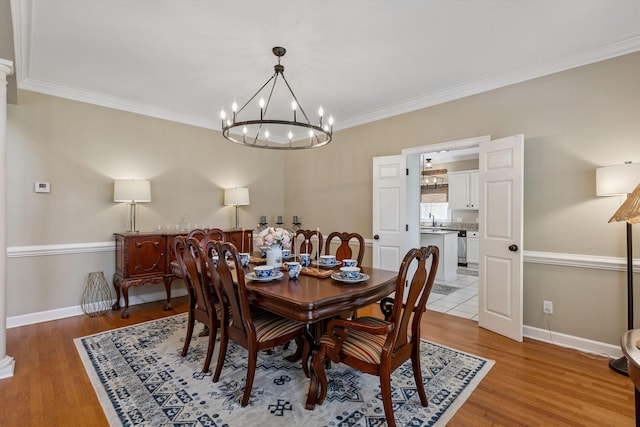 927 Oakmont Ridge Cv, Collierville, TN 38017 - dining space with a chandelier, ornamental molding, and light wood-style flooring
