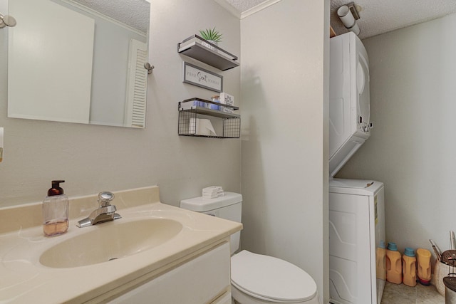 4764 Eagle Crest Dr Unit 4002, Memphis, TN 38117 - bathroom featuring stacked washer / drying machine, a textured ceiling, vanity, and ornamental molding