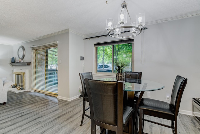 4764 Eagle Crest Dr Unit 4002, Memphis, TN 38117 - dining space with a chandelier, wood finished floors, ornamental molding, a textured ceiling, and a fireplace