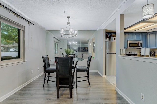 4764 Eagle Crest Dr Unit 4002, Memphis, TN 38117 - dining area featuring a chandelier, a textured ceiling, light wood finished floors, and ornamental molding